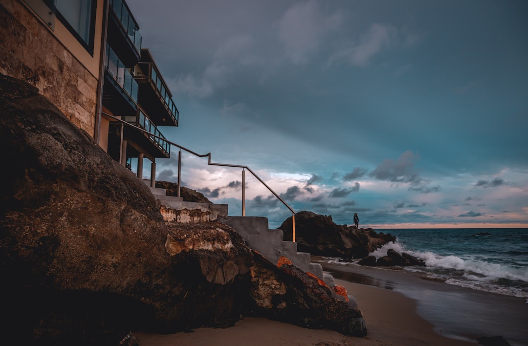 a building on a cliff by the ocean