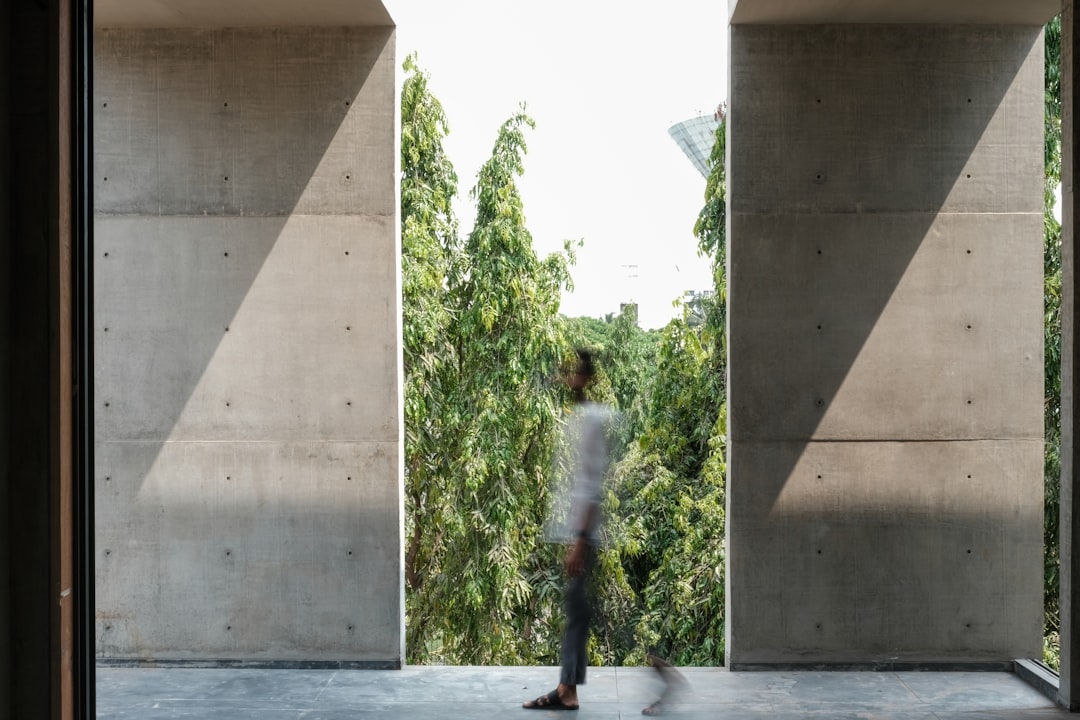 a person standing in front of a concrete wall