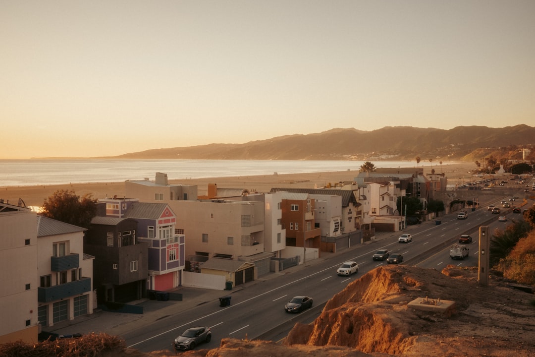 Coastal town with ocean and mountains at sunset